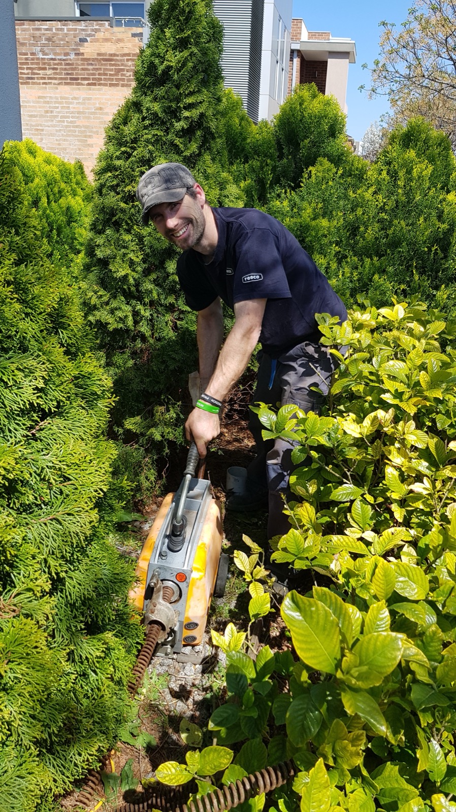 A worker using drain-clearing equipment