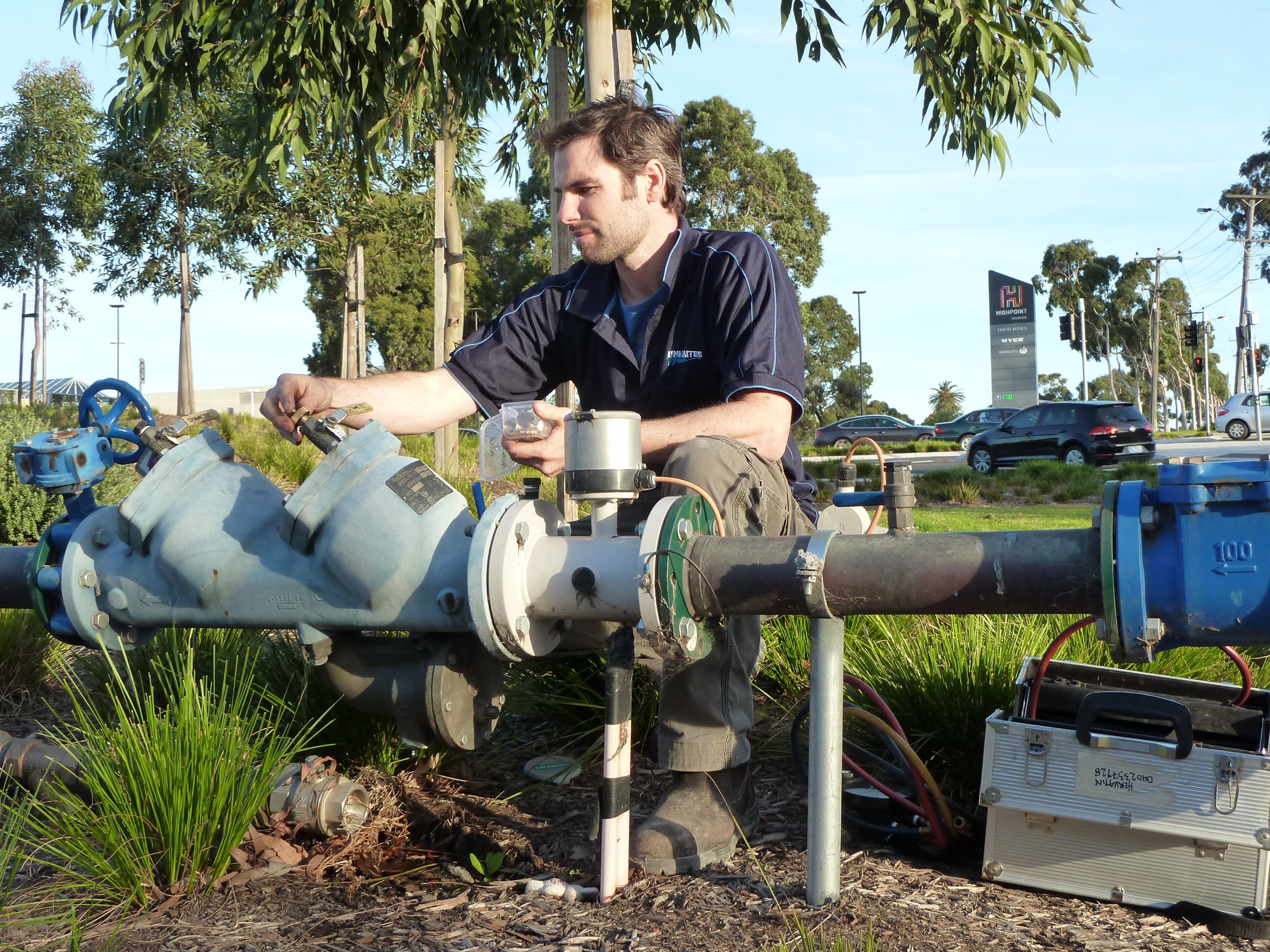 HTS Plumbing working on outdoor water-pipe equipment