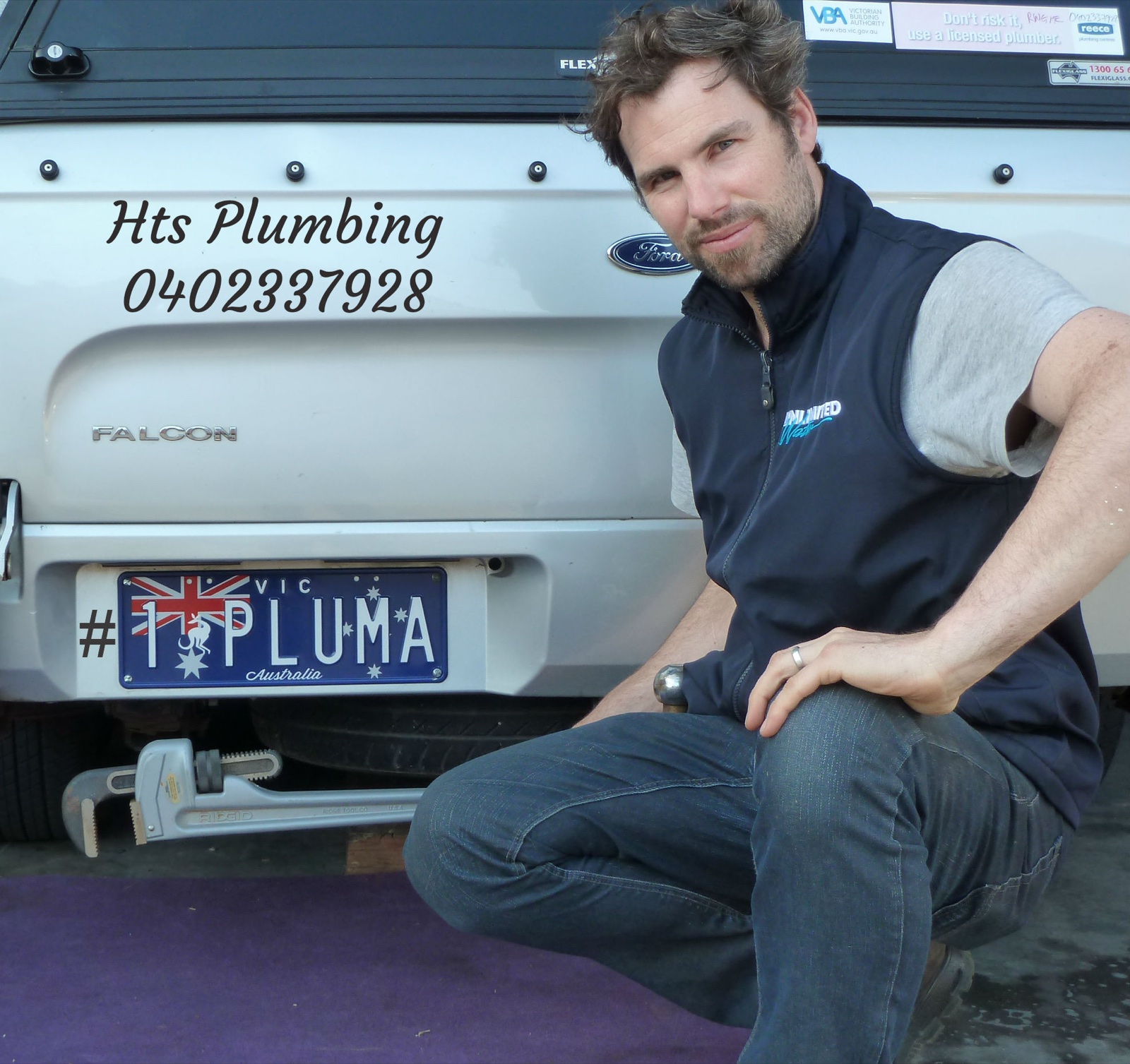 A HTS Plumbing worker beside the business vehicle